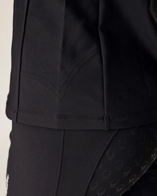 Detailed back view showing the flattering seams of the black riding top and the high waistband of the matching breeches.
