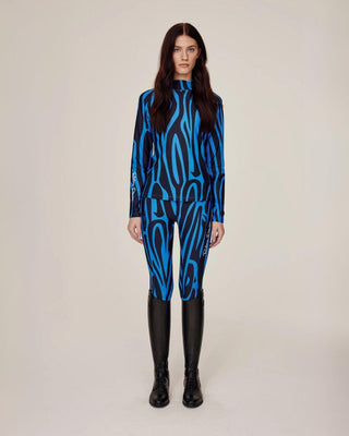 Full body front view of a model wearing the matching blue zebra riding set, including the technical top and high-waisted breeches.