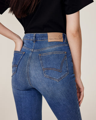 Close-up product shot of the back of the jeans breeches, detailing the pockets, stitching, and logo.